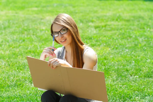 Woman with folder in park