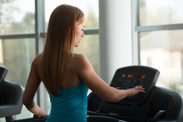 Woman staying on treadmill