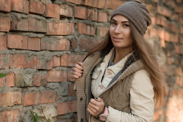 Beautiful woman posing over brick wall