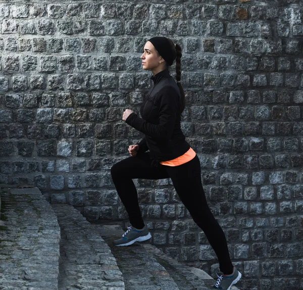 Young athletic woman running up