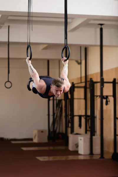 Athlete hanging on gymnastic rings