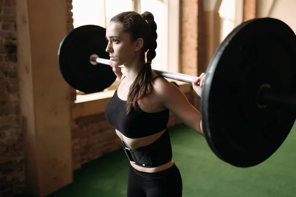 Strong woman lifting barbell