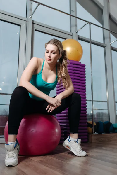 Sportswoman sit on fitball