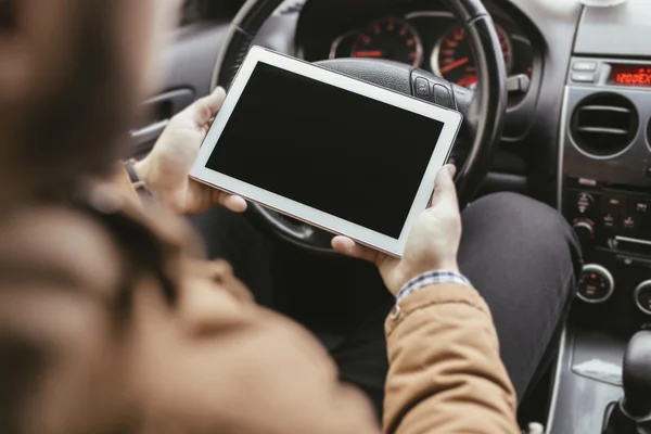 Man in the car with tablet PC
