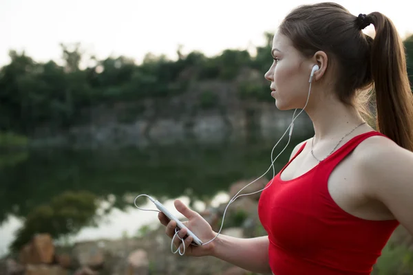 Young woman listen music before jogging