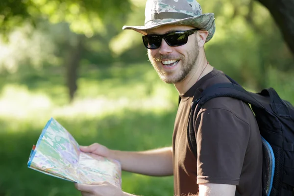 Male explorer looking at a map outdoors