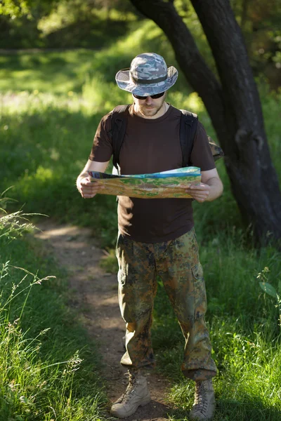 Male explorer looking at a map outdoors