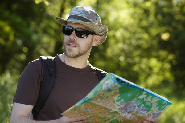Male explorer looking at a map outdoors