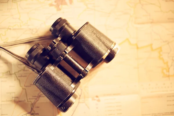 Vintage binocular on map background