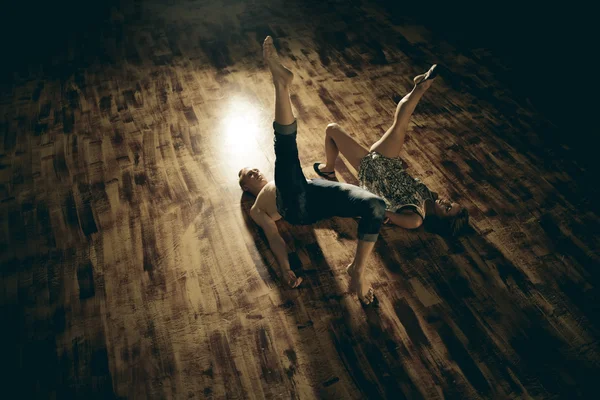 Couple dancing contemporary on floor, top view