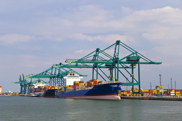 Huge container ship loaded with cranes in Port of Antwerp container terminal