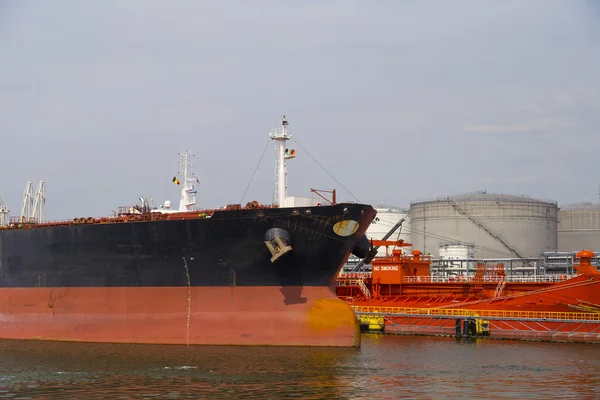 Oil tanker moored near an oil silo in Port of Antwerp