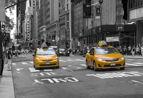 NEW YORK CITY, USA - AUGUST 30, 2014. Famous yellow-coloured taxi cabs in monochrome