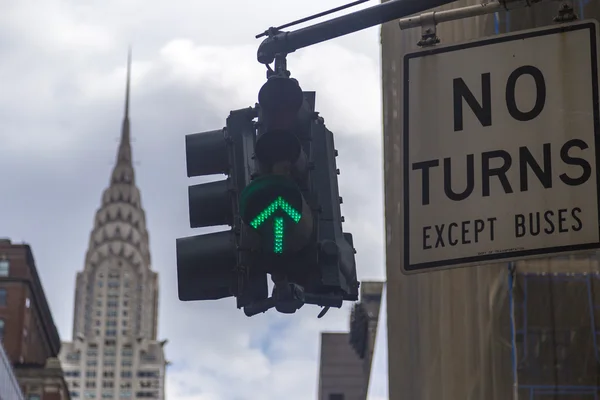 NEW YORK CITY, USA - AUGUST 30, 2014. No turns road sign with green arrow and Chrysler building