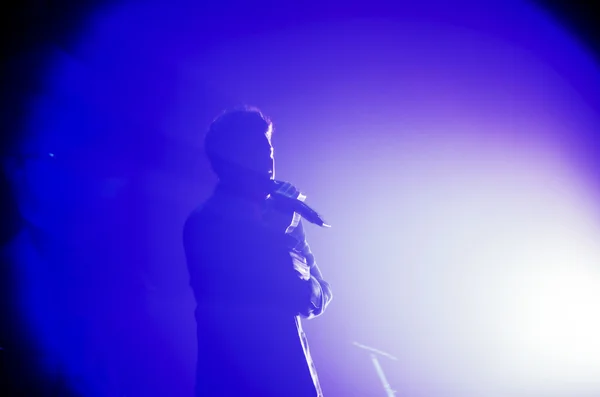A singer man silhouette on stage