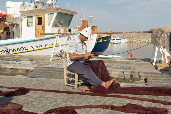 Paros, Greece 15 August 2015. Fisherman repairing the net at Paros island in Greece.