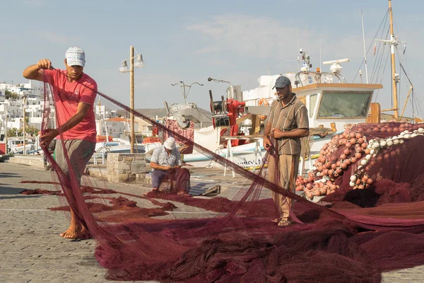 Paros, Greece 15 August 2015. Fishermen on their everyday work repairing the fishing net at Paros island in Greece.