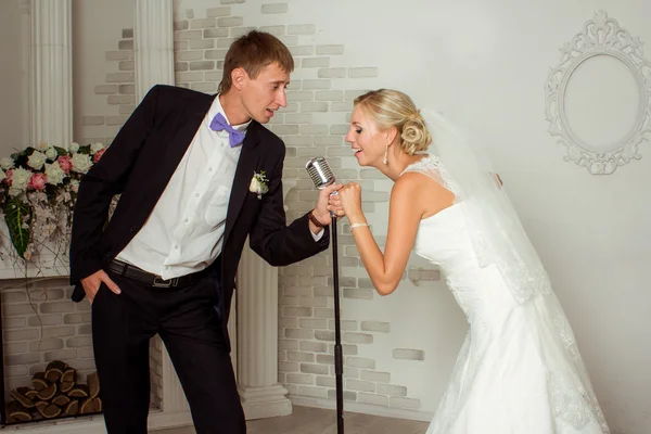 A wedding couple are singing a song