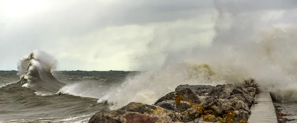 Large Waves crashing against rocky shoreline