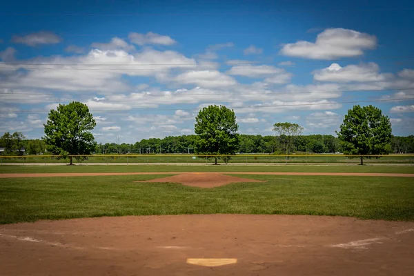 Baseball Field with Blue Sky and Clouds