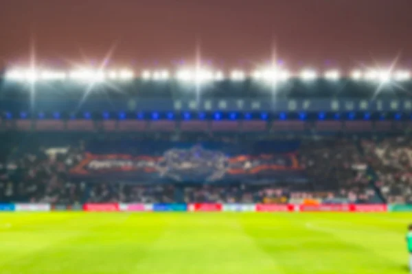 Blurry de-focused stadium football  twilight background.