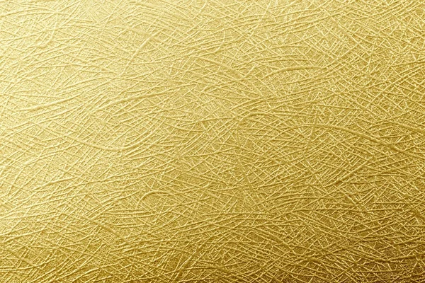 Golden paper foil on background texture.