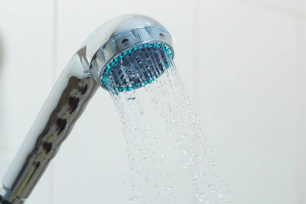 Shower with water steam in the bathroom.