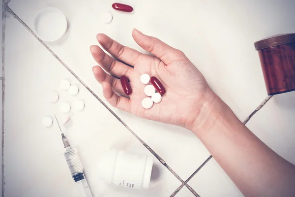 Focus on hand women after eaten pills overdose.