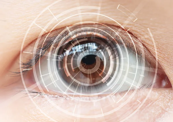 Close-up of woman\'s brown eye. High Technologies in the future