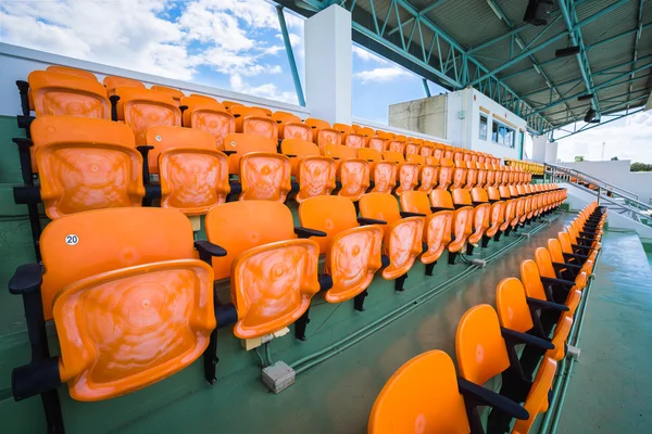 Orange empty seat of indoor stadium.