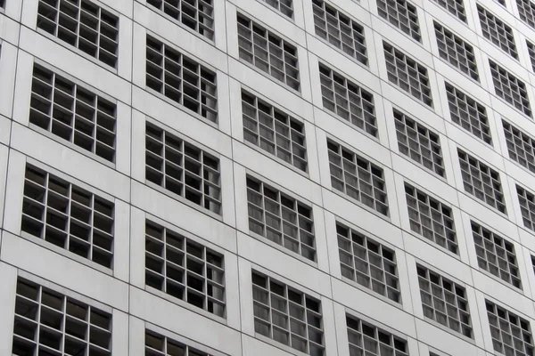 Perspective and underside angle view pattern of office building windows background.