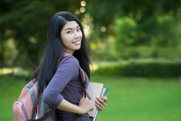 Asian college student on campus in park