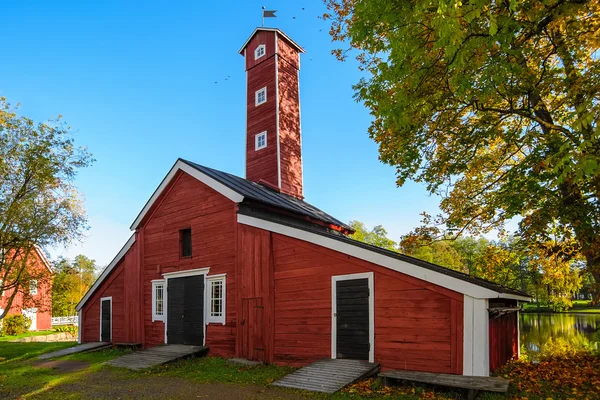 Old factory hose tower of red ochre painted wood