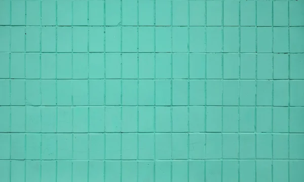 Teal blue painted ceramic tile wall