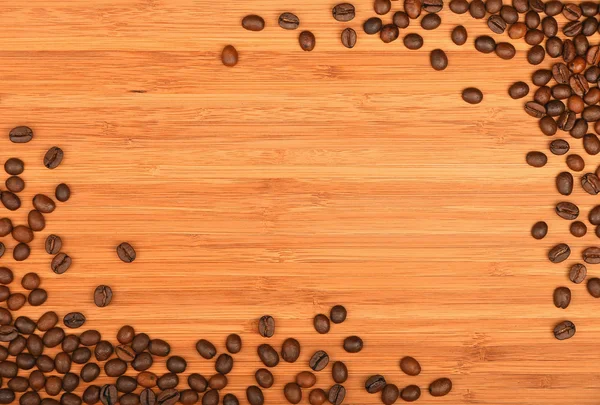 Coffee beans corners over bamboo wood background