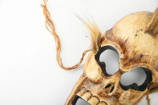 Wooden carved skull death mask on white