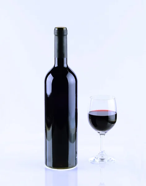 Bottle and glass of red wine isolated on white background.
