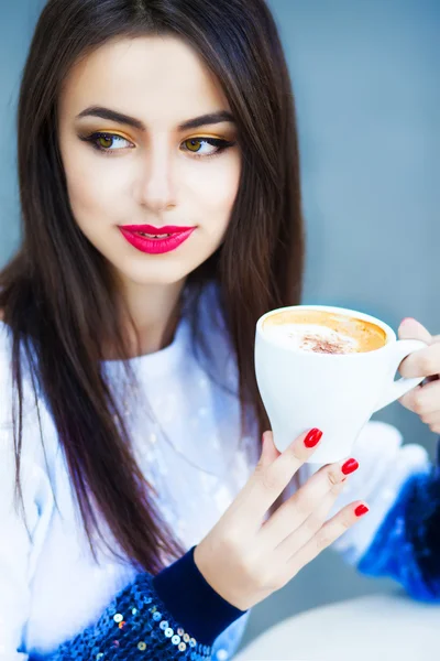 Cute pretty woman drinking coffee