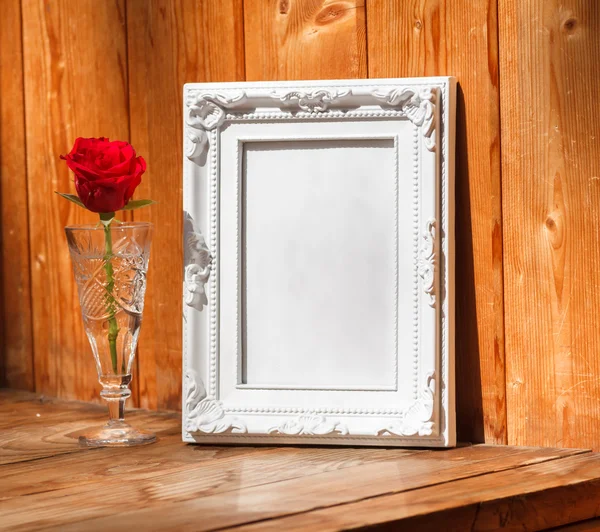White frame and bunch of red roses
