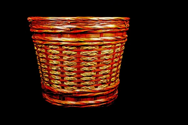 Woven Rattan Waste Paper Bin on Black Background