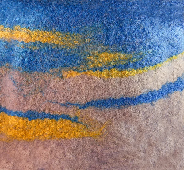 Texture colored felted fabric of dyed sheep\'s wool and viscose.