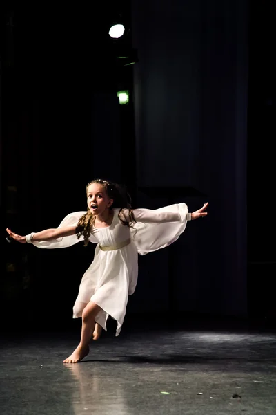 Girl dancer in white running across the stage stretched his hand