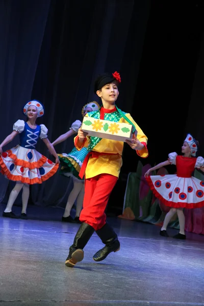 The boy in the Russian folk costume dance folk dance.