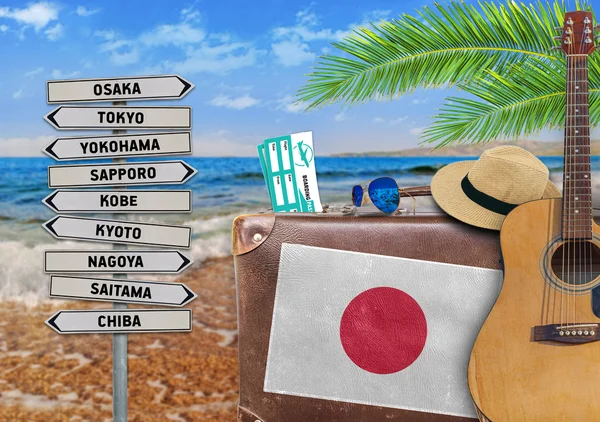 Concept of summer traveling with old suitcase and Japan town sign