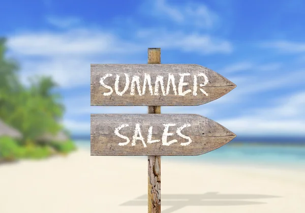 Wooden direction sign with summer sales
