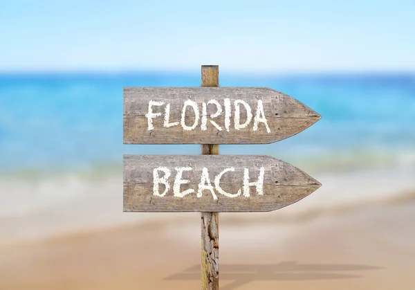 Wooden direction sign with florida beach