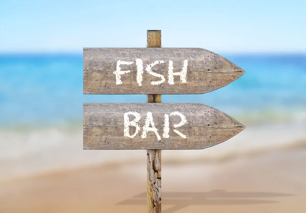 Wooden direction sign with fish bar