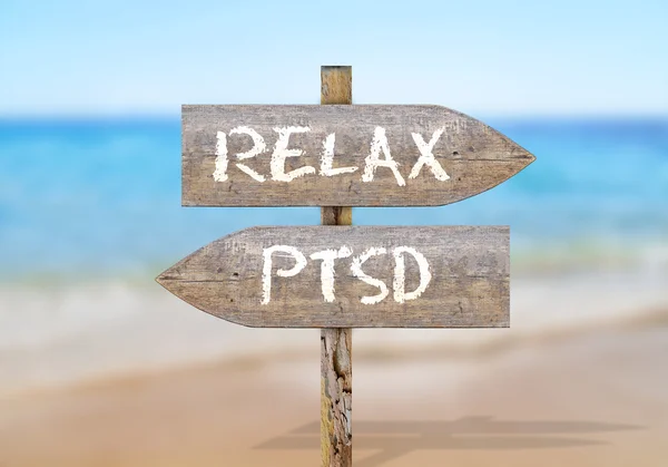 Wooden direction sign with relax and ptsd