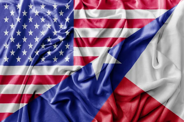 Ruffled waving United States of America and Texas flag