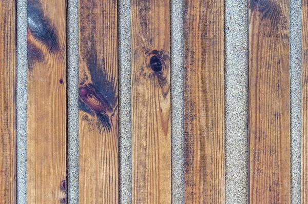 Close up shot of a wooden beach path texture with some sand